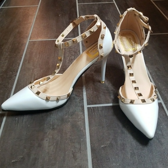 white heels with gold accents